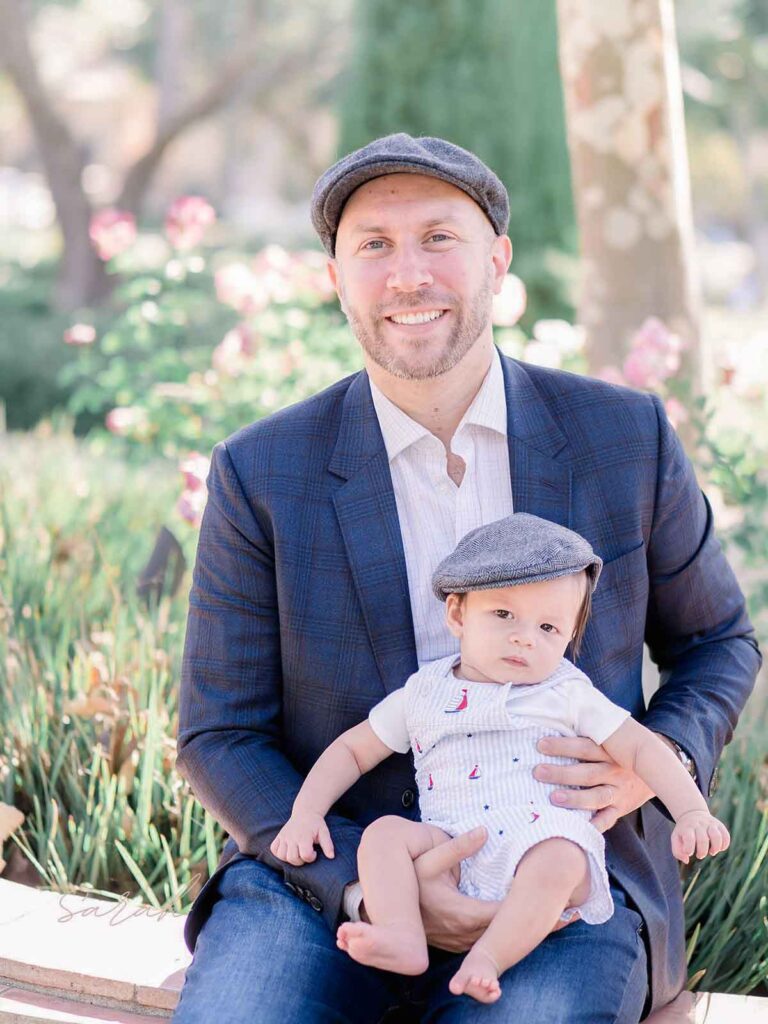 father posing with six month old baby boy