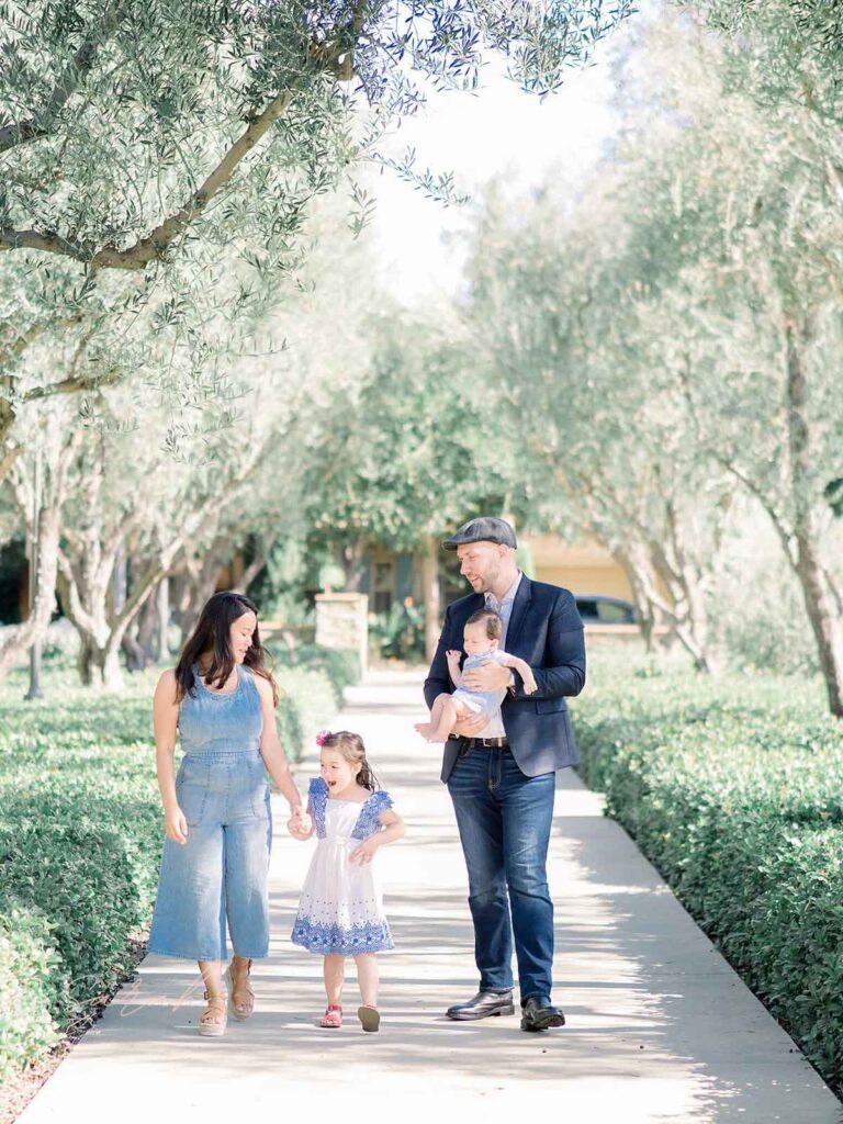 family walking together in a pretty park