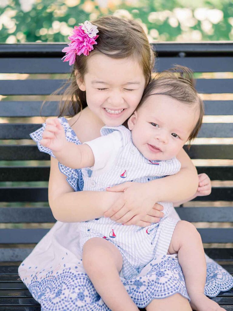 sister posing with baby brother
