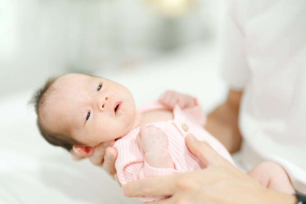 a baby in a pink outfit