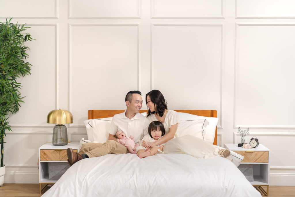 a family sitting on a bed