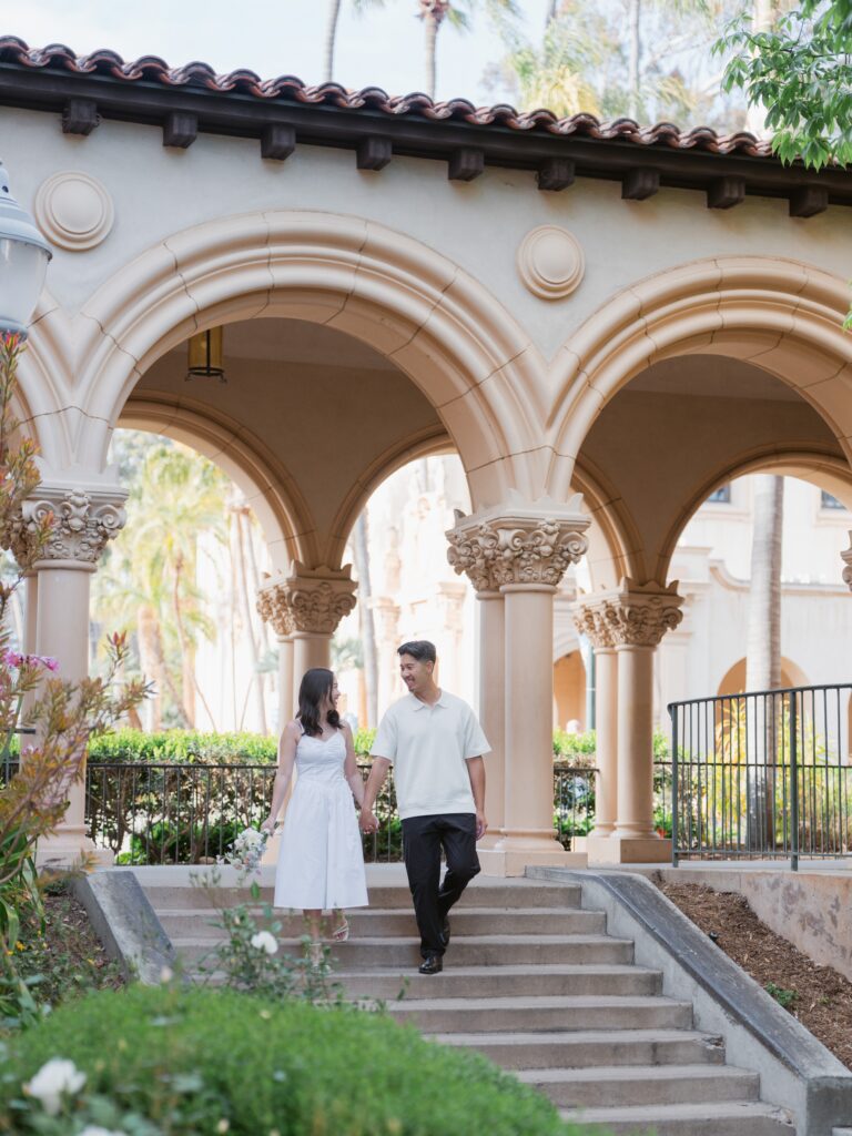 Couple walking through Balboa Park during their engagement session